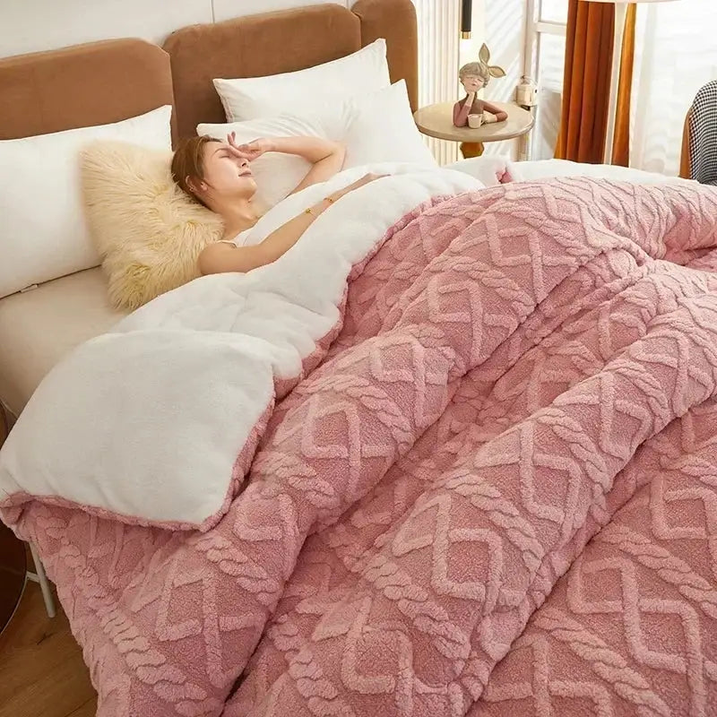 Pink plush quilt with textured geometric pattern and white fleece lining for decorbites cozy winter bed blanket