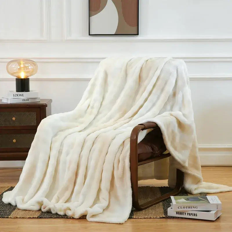 Cream-colored fuzzy faux fur throw blanket draped over wooden chair featuring soft plush texture decorbites fuzzy faux