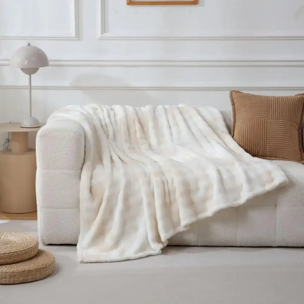 Cream-colored fuzzy faux fur blanket draped over sofa perfect for cozy decorbites fuzzy faux bedroom throw decor