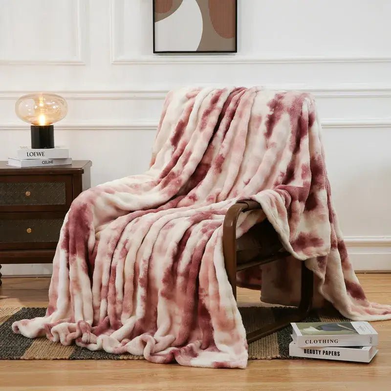 A soft pink and cream tie-dye fuzzy faux fur blanket with fluffy texture for cozy bedroom decorbites fuzzy faux throw