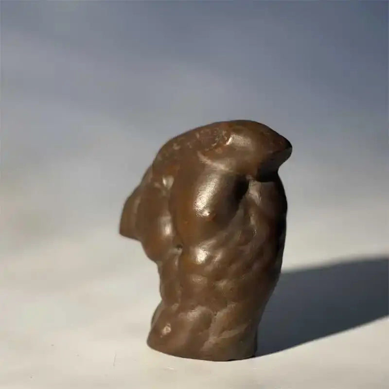 Bronze-colored textured sculpture of a muscular greek nude human figure bust for living room decor