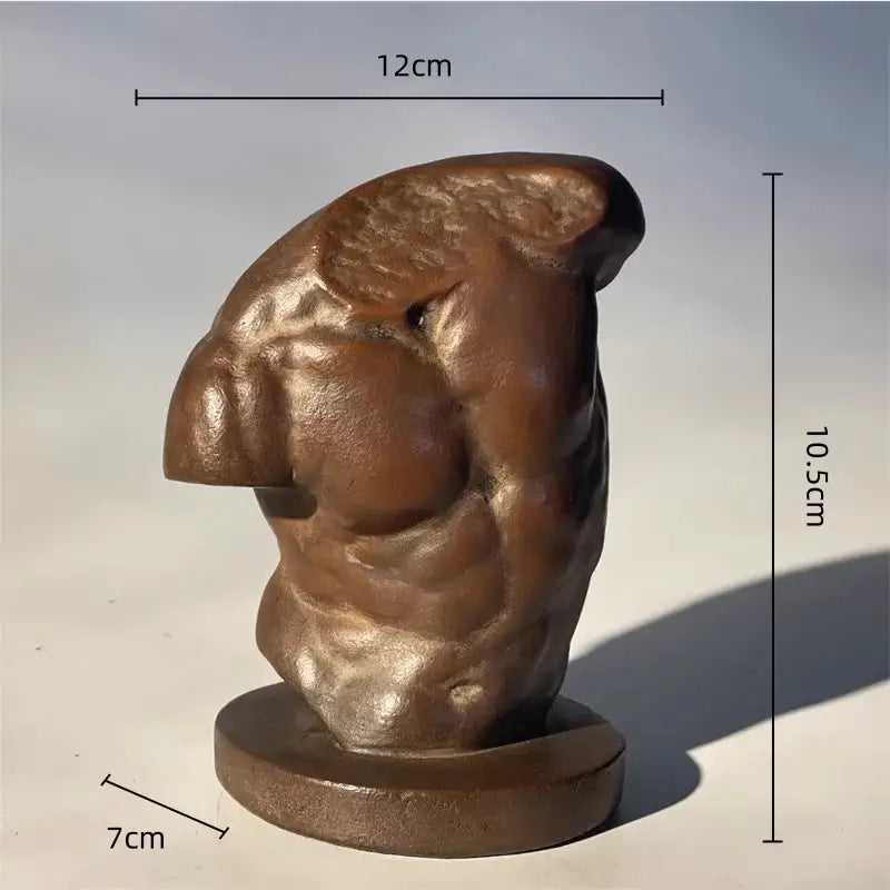Bronze-colored sculpted greek nude human figure bust of a muscular male torso on a circular base for living room decor