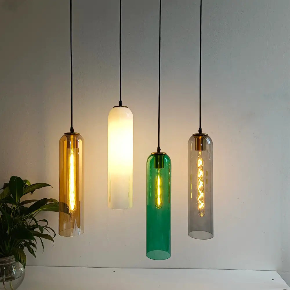 Four hanging pendant lights in amber, frosted white, emerald green, and clear glass green glass nordic design for living room