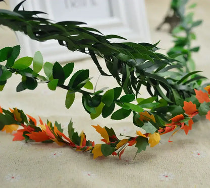 Decorative green and orange artificial leaf vine wreath garland for autumn living room decor