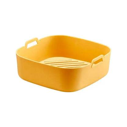 Bright yellow rectangular silicone baking tray with integrated handles and slotted base for air fryer silicone pot use