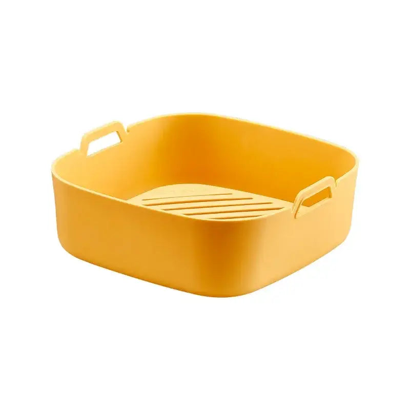 Bright yellow rectangular silicone baking tray with integrated handles and slotted base for air fryer silicone pot use