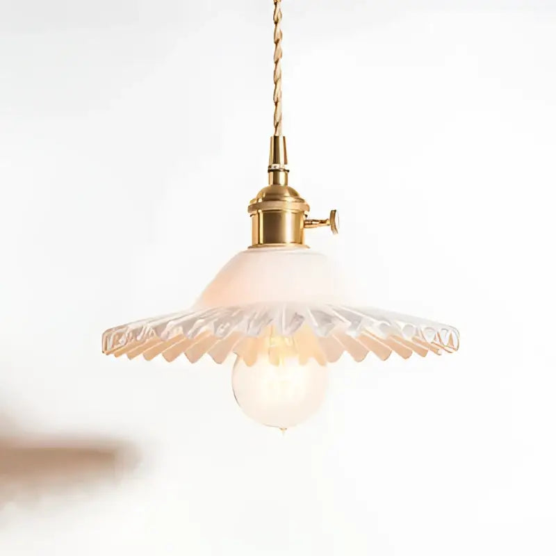 Delicate brass pendant light with scalloped translucent glass shade and exposed bulb on decorbites copper base glass fixture