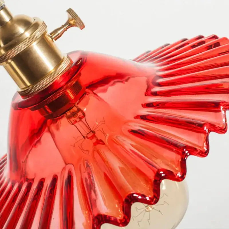 Vibrant red glass pendant light with fluted edges and brass decorbites copper base for dining room decor