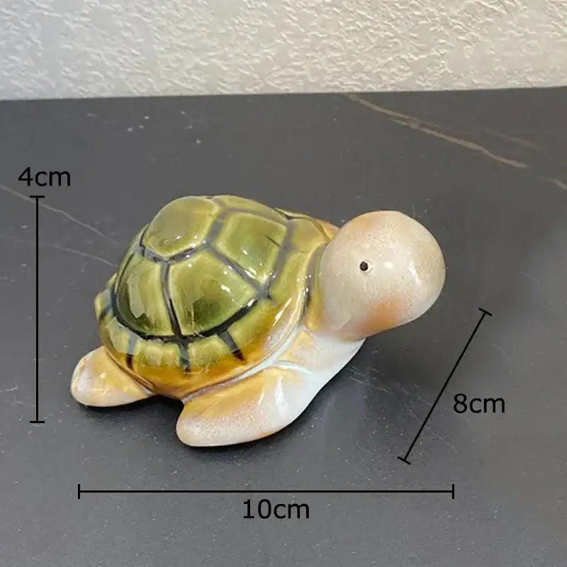 Green and cream ceramic cute turtle statue tray with green and yellow shell and black detailing for living room decor