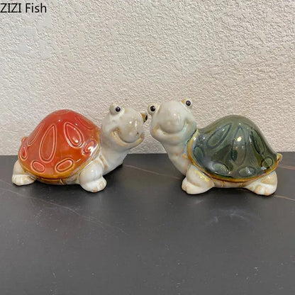 Green and cream ceramic cute turtle statue tray featuring two smiling ceramic turtle statues with orange and greenish-blue shells