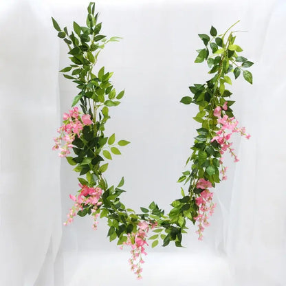 Green and white artificial flowers garden wedding arch decor with delicate pink blossoms and synthetic vine leaves by decorbites artificial flowers
