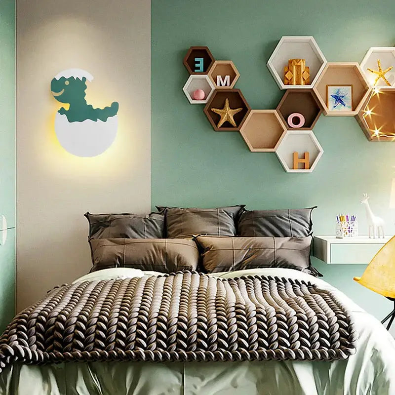 Teal dinosaur-shaped decorbites dino egg led wall lamp with white eggshell outline emitting warm light night light