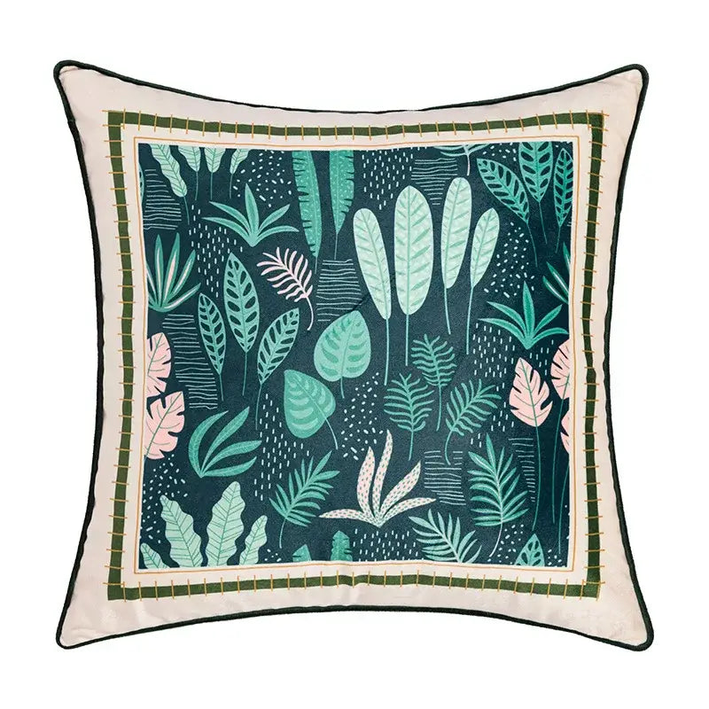 Square cushion cover with vibrant teal green pink tropical leaves on dark background and off-white geometric tufted embroidery detailing by decorbites
