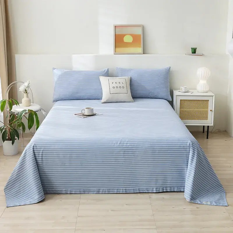 Light blue striped cotton bed sheet with fine white stripes complementing decorbites cartoon printed cotton bedspread