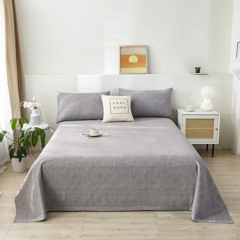 Gray textured bedspread with subtle woven pattern draped on mattress complements decorbites cartoon printed bedspread