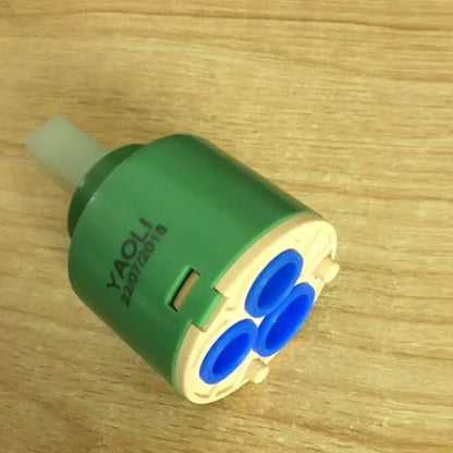 Green and beige plastic ceramic cartridge with three blue openings for kitchen faucet mixer with 3-year warranty