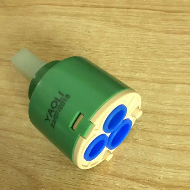 Green and beige plastic ceramic cartridge with three blue openings for kitchen faucet mixer with 3-year warranty