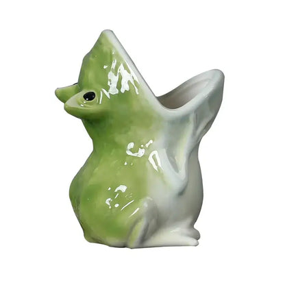 A glossy green and white ceramic duck flower pot with a wide open beak complementing decorbites cute frog decor