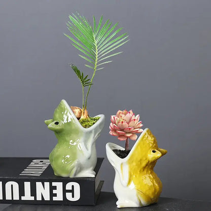 Two ceramic flower pots in green and yellow featuring decorbites cute frog succulent designs for garden decor