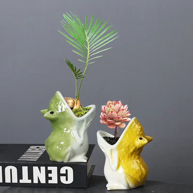 Two ceramic flower pots in green and yellow featuring decorbites cute frog succulent designs for garden decor