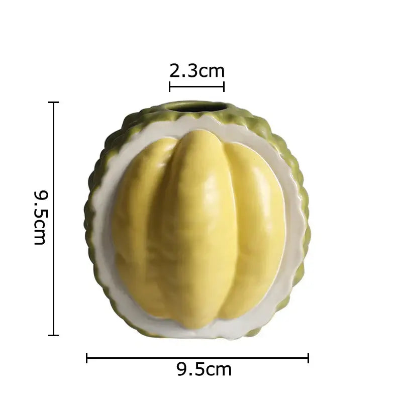 Green and yellow durian ceramic vase shaped like a halved durian with vibrant flesh for table decor and living room use