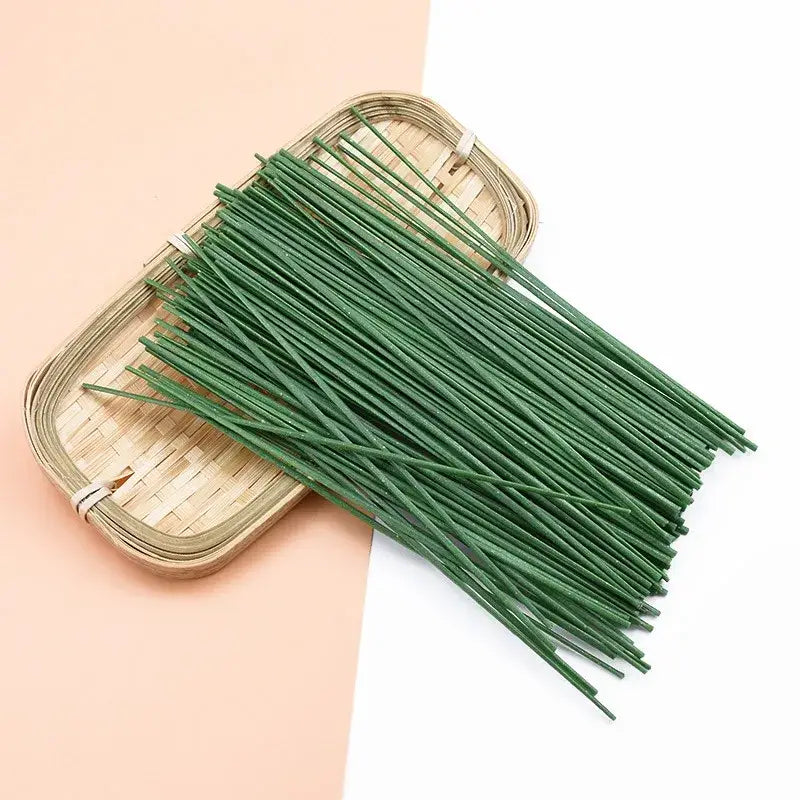 A bundle of green decorbites iron wire roses stems made of iron wire for artificial flowers wedding decor on a bamboo tray
