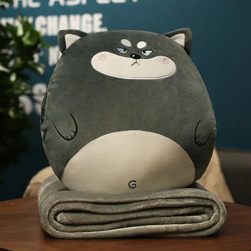Gray plush husky cartoon animal throw pillow blanket with white accents and embroidery resting on gray fleece decorbites pillow blanket