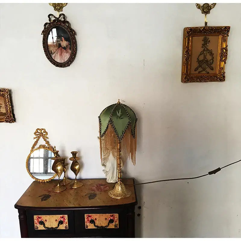 Vintage-style table lamp with green bamboo leaf jacquard satin shade and brass fringe on ornate golden base