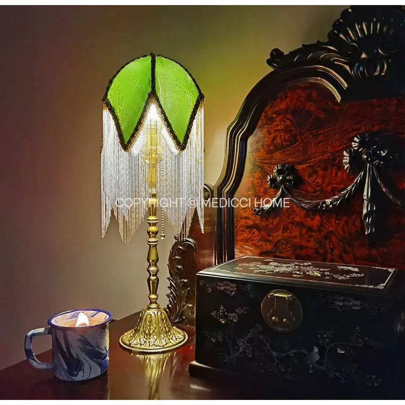 Vintage-style table lamp with green bamboo leaf jacquard satin shade and ornate brass fringe base for bedroom decor
