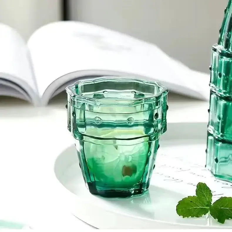 A translucent green glass mug with a faceted hexagonal design and bead embellishments by decorbites cactus glass