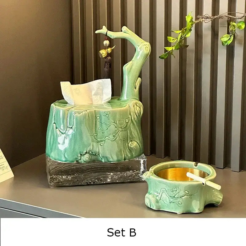 A jade-green ceramic bamboo tissue box with tree branch design and matching ashtray featuring floral carvings for living room decor