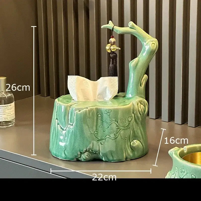 Green ceramic bamboo tissue box shaped like a tree stump with a branch and tassel for living room decor