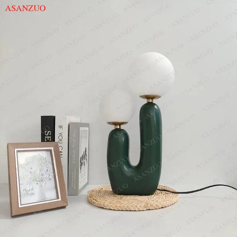 Dark green ceramic table lamp with double frosted glass white spherical shades for bedroom use