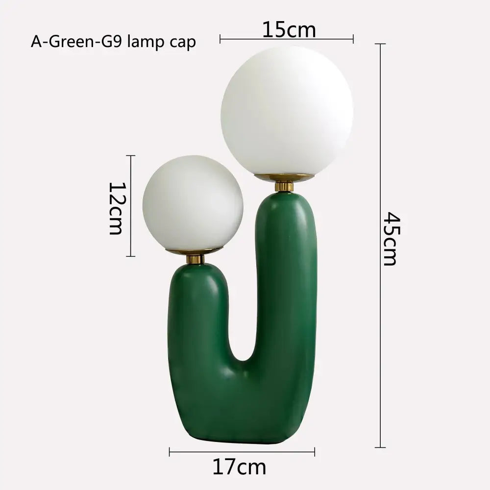 Modern green ceramic table lamp with double frosted glass spherical shades for bedroom use
