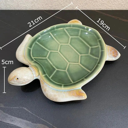 Green ceramic turtle statue desk decoration with glossy shell and cream limbs for bedroom trinket dish use