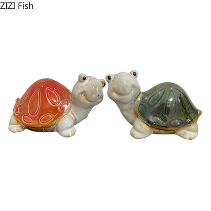 Two ceramic turtle statue desk decorations with glossy orange and green shells and smiling faces for bedroom trinkets
