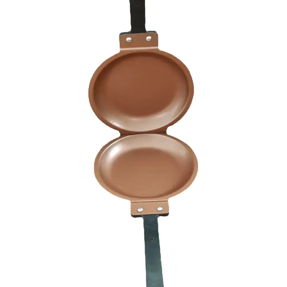 Copper-colored double sided pancake frying pan with black handle and metal rivets for green double sided pancake use