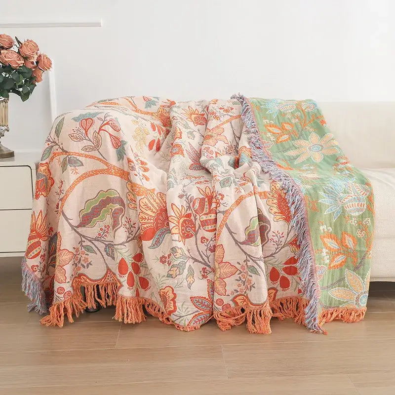 Cozy two-toned green floral cotton tassel sofa blanket with vibrant orange accents and soft fringed edges for living room decorbites cotton tassel
