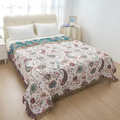 A cream decorbites cotton tassel sofa blanket with green floral paisley patterns and textured fringe for living room decor