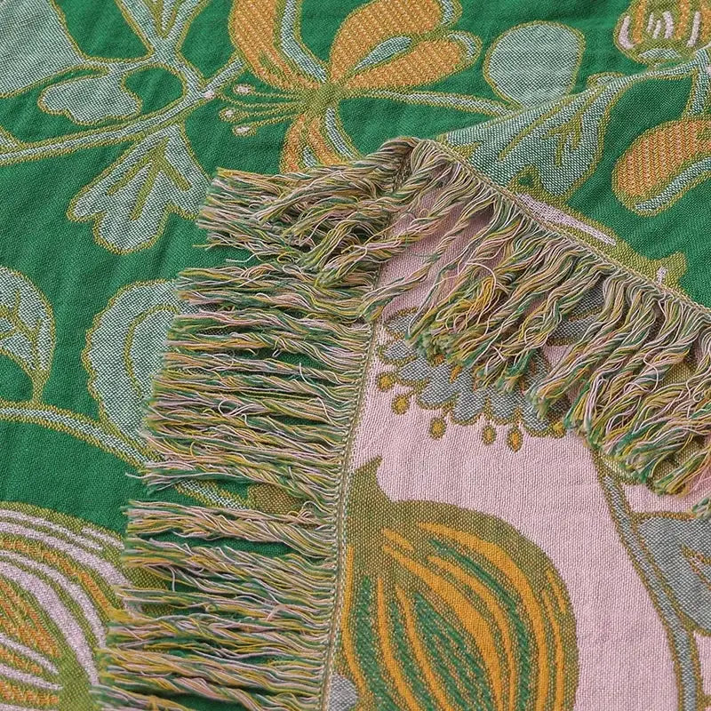 Green floral cotton tassel sofa blanket featuring a vibrant woven cotton tassel decorbites design with botanical pattern and fringe