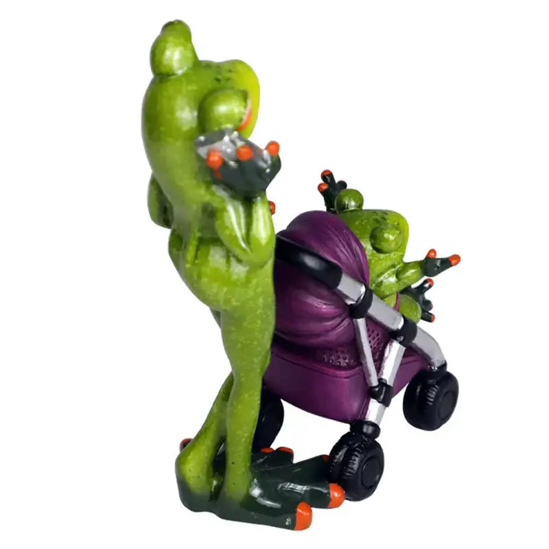 Green frog family statue set resin figurine with orange-tipped toes holding device pushing purple stroller decorbites frog family