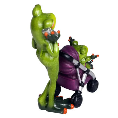 Green frog family statue set resin figurine with orange-tipped toes holding device pushing purple stroller decorbites frog family