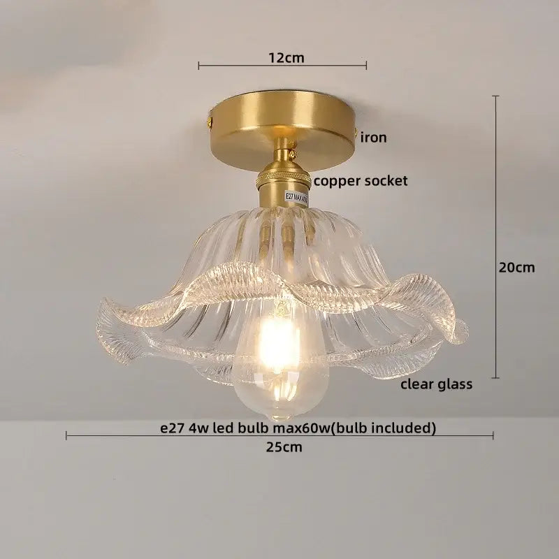 A clear glass pendant ceiling lamp with gold-toned iron and copper nordic socket featuring ruffled design