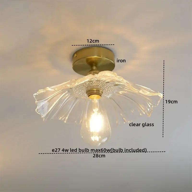 A delicate clear glass copper nordic ceiling lamp with brass iron base and petal design for living room lighting