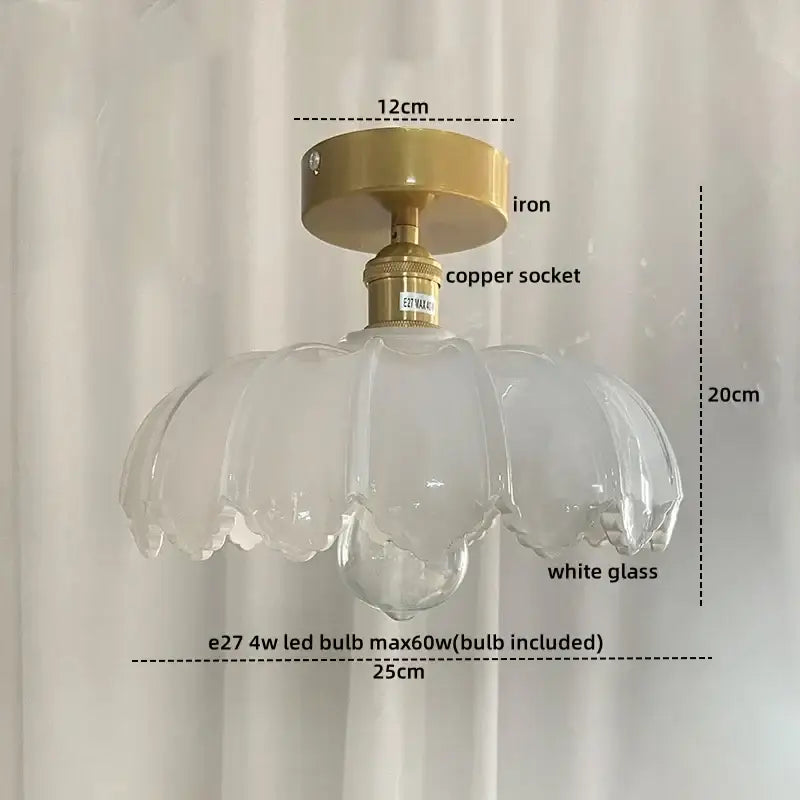 A delicate white glass pendant ceiling lamp with gold-toned iron and copper socket in a copper nordic ceiling design