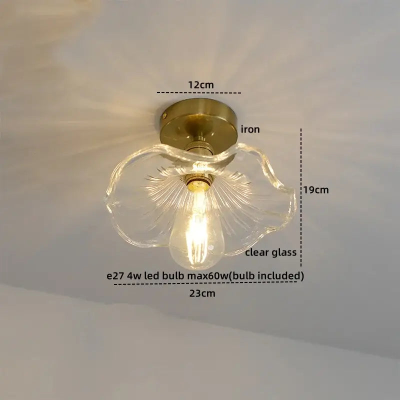 A delicate clear glass flower-shaped ceiling lamp with brass copper nordic base and e27 led bulb for living room