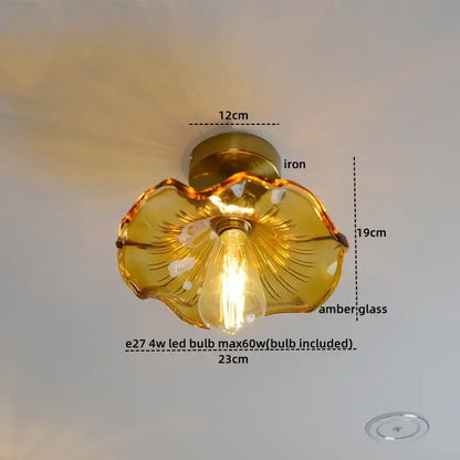 A golden amber glass flower-shaped ceiling lamp with iron base and visible led bulb in copper nordic style