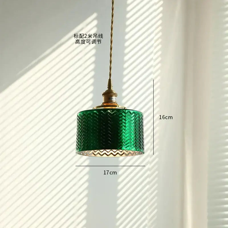 Emerald green glass pendant light with textured chevron pattern and brass decorbites copper canopy for dining room
