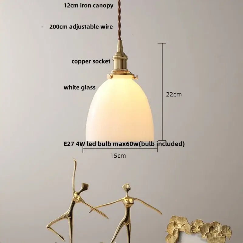A warm pendant light with white glass shade and brass-finished iron canopy complements decorbites copper canopy led