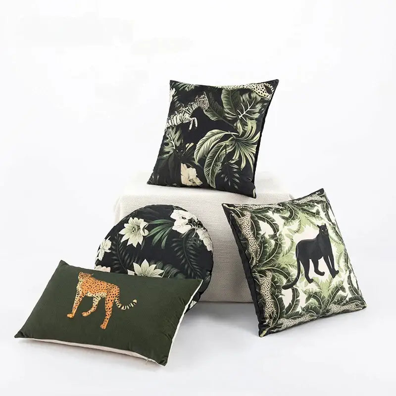 Set of four premium cushion covers in black, olive green, and cream with embroidered panther motifs for green jungle decor